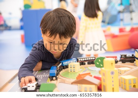 Children playing indoors Royalty-Free Stock Photo #655357816