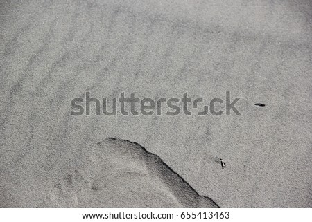 Gray sand surface with a cut line. Gray sand texture. Background sand. Seamless texture of sand