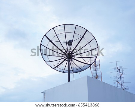 Satellite and blue sky background set up on top view of condominium building 