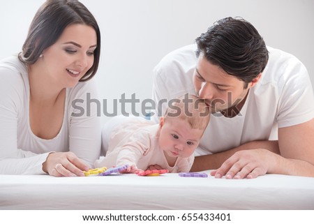 An image of a happy family of three