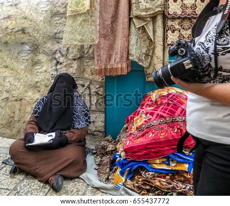 Saleswoman in hijab at the bazaar in the center of Bethlehem