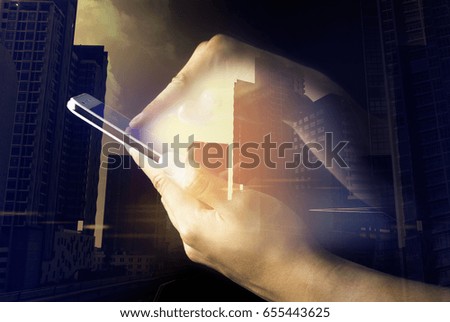 hand touch smart phone on building background