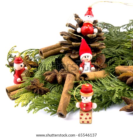 Closeup picture of thuja branches, spices and small wooden figure on white background.