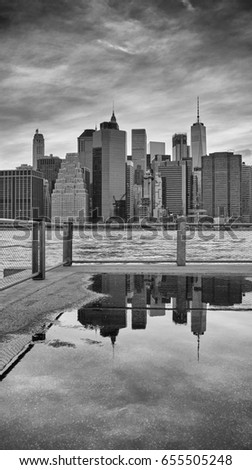 Manhattan skyline reflected in a puddle, Brooklyn Borough, New York City, USA.