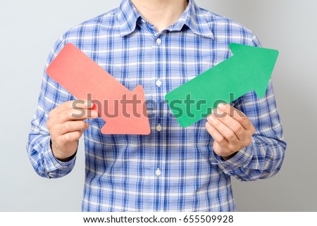 Man holding arrows with rising colorful graph