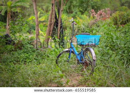 Old vintage bicycle with blue basket