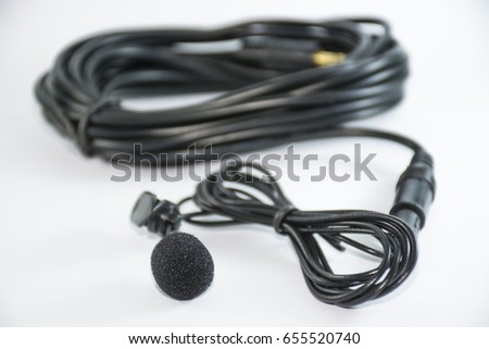 close up tie-clip on microphone , black color , white background