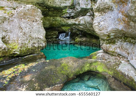 Green pool and waterfall in rocky gorges of river Gljun, Soca valley, Bovec, Slovenia, water background, turquoise, mountain river, stream, Virje waterfal, Triglav national park, Europe