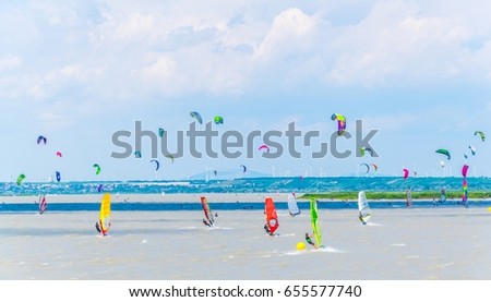 young people are kite surfing on the neusiedlersee lake in Austria near Podersdorf am See town.
 Royalty-Free Stock Photo #655577740