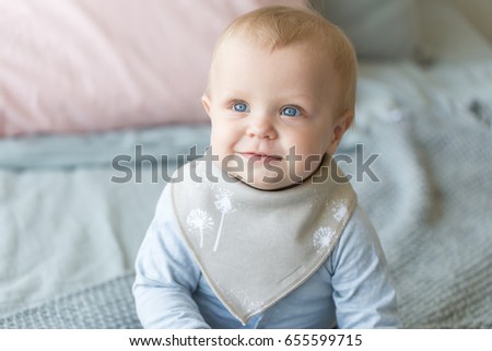 Infant baby posing in bib Royalty-Free Stock Photo #655599715