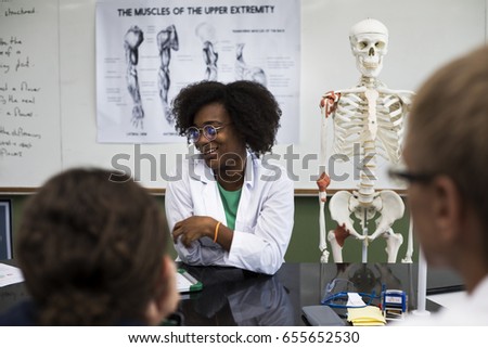 Biology teacher teaching biology to diverse group of high school students Royalty-Free Stock Photo #655652530