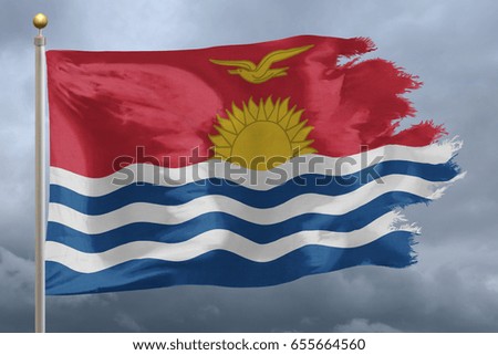 Kiribati Flag with torn edges in front of a stormy sky