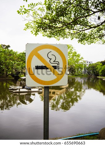 This picture is label no smoking metal sign in the park