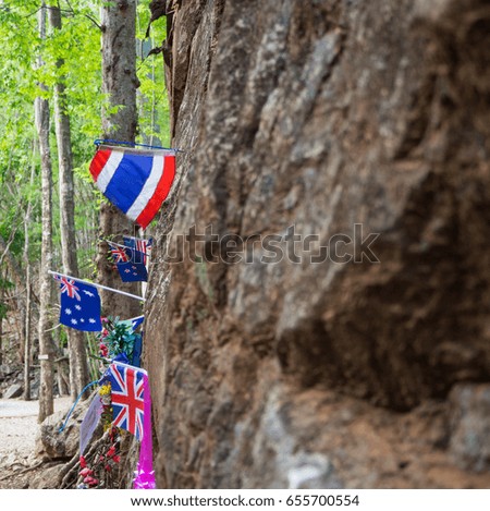 National flag on boulder background in the forest at kanchanaburi Thailand use for memorial of those who died