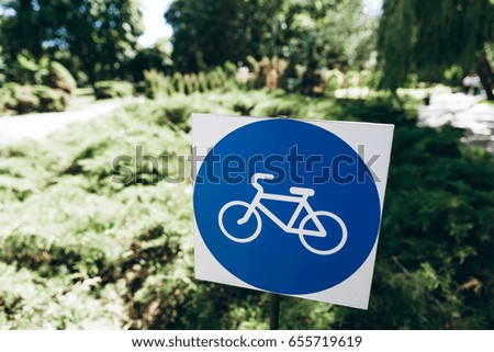 Sign of white bicycle on blue background with copy space.