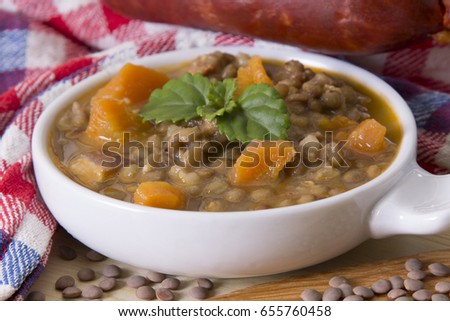 Lentil casserole on the wooden table on the red tablecloth
