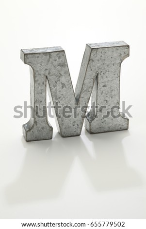 iron letter M isolated on white