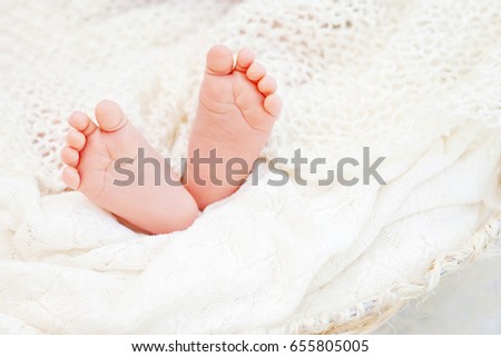 Close up picture of new born baby feet on knitted plaid.  Happy Family concept.