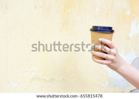 Female hand with cup and beautiful jewelry