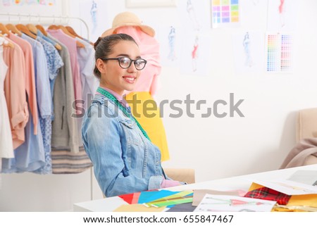 Young female fashion designer at workplace