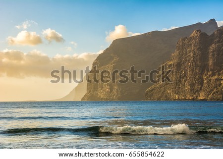Amazing view of mountain peaks with beautiful clouds on the sunset. Location: Tenerife, Canary Islands, Spain. Artistic picture. Beauty world.