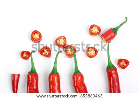 Red chilli or chili peppers cut into pieces isolated on a white background. Royalty-Free Stock Photo #655860463