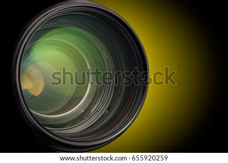 Camera lens close up isolated on dark background.