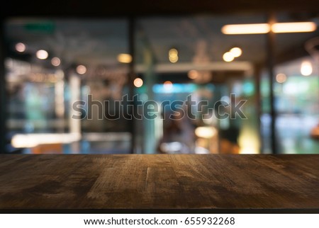 Empty wooden table in front of abstract blurred background of coffee shop . can be used for display or montage your products.Mock up for display of product Royalty-Free Stock Photo #655932268