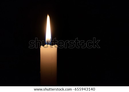Single lit candle with quite flame 
