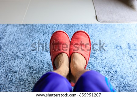 house slipper shoe in living room with blue carpet softness