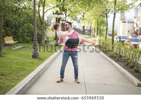 A picture of a joyful couple in a park road