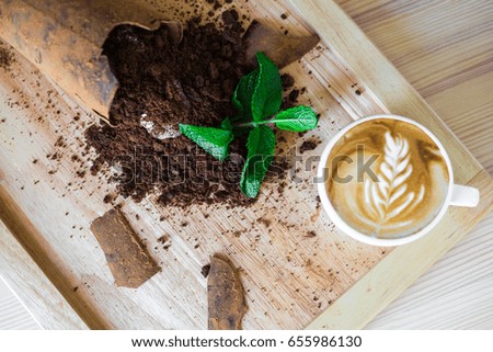 Close-up on a wooden board, trendy, tasty, chocolate dessert with ice cream, decorated with mint, beautiful stylish serve, cappuccino, restaurant, top view