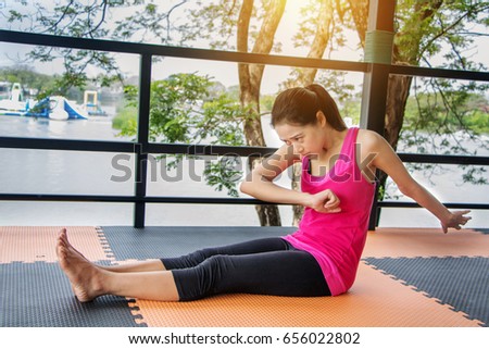 Asian woman wearing pink shirts Exercise by stretching the body.