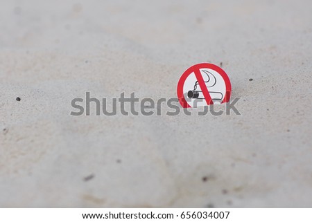 "No smoking" sign on the beach on white sand background
