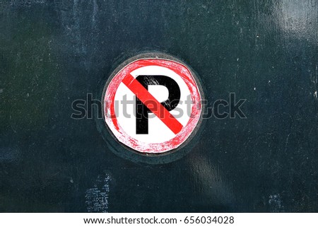 No parking sign. Grunge shabby paper sticker on the garage entrance door. Prohibition symbol. Sign indicating warning and forbidden. Photo 