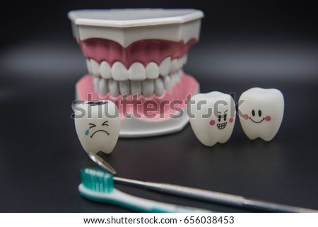 Model Cute toys teeth in dentistry on a black background.