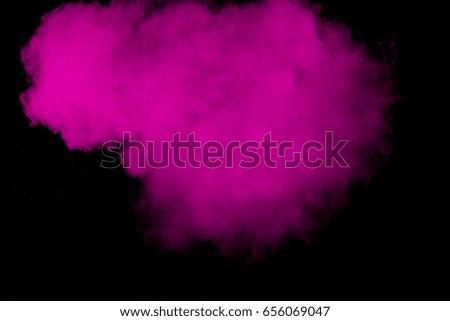 abstract pink color powder splatted on black background