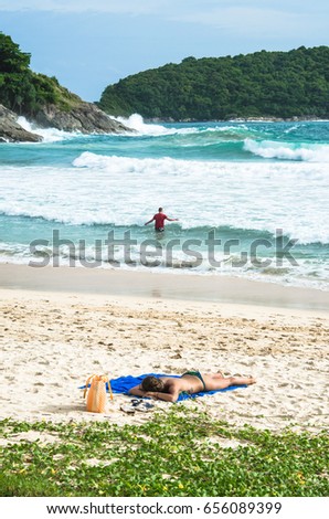 A girl sunbath on the beach Phuket, Thailand.
