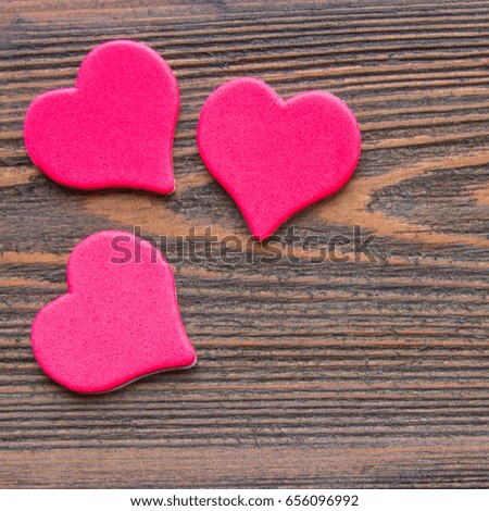 hearts on a wooden background.. A square image.