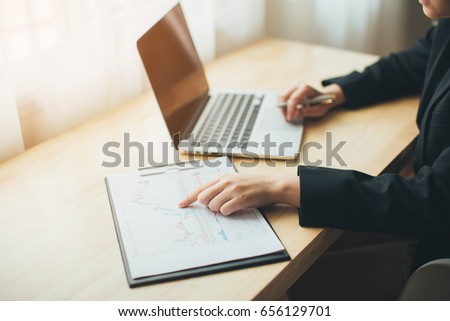 Professional business woman at work with laptop hands close up