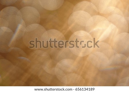 Blurred natural background of sun rays and bokeh circular shape