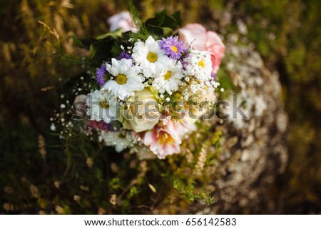 The bride's bouquet of beautiful natural flowers on the wedding day