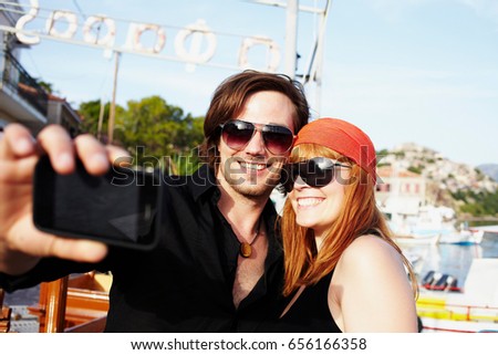 Couple taking picture in front of harbor