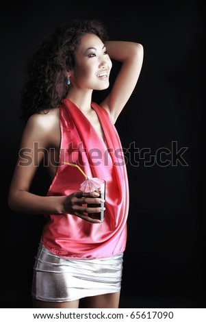 Shot of an attractive young woman posing over black background.