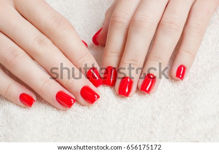 Manicure - Beauty treatment photo of nice manicured woman fingernails with red nail polish. Royalty-Free Stock Photo #656175172