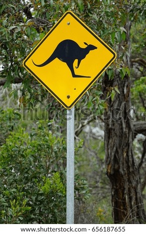 A yellow kangaroo crossing road sign