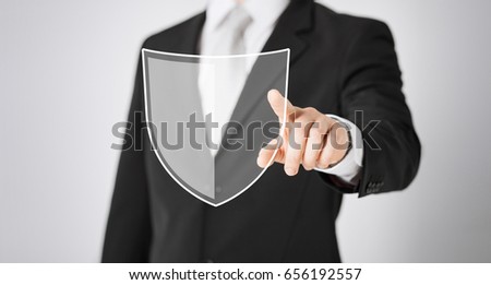 business, people and cyber protection concept - close up of man pointing his finger at virtual antivirus program shield icon over gray background