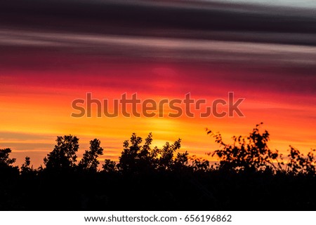 Beautiful summer sunset. Colors reminds the flag of Germany. Background picture.