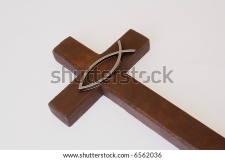 Religious fish sign over wooden cross