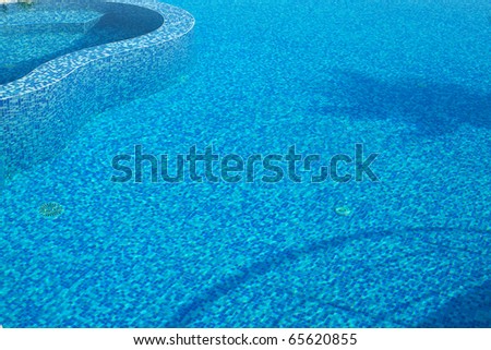 Blue water in a pool with tiles